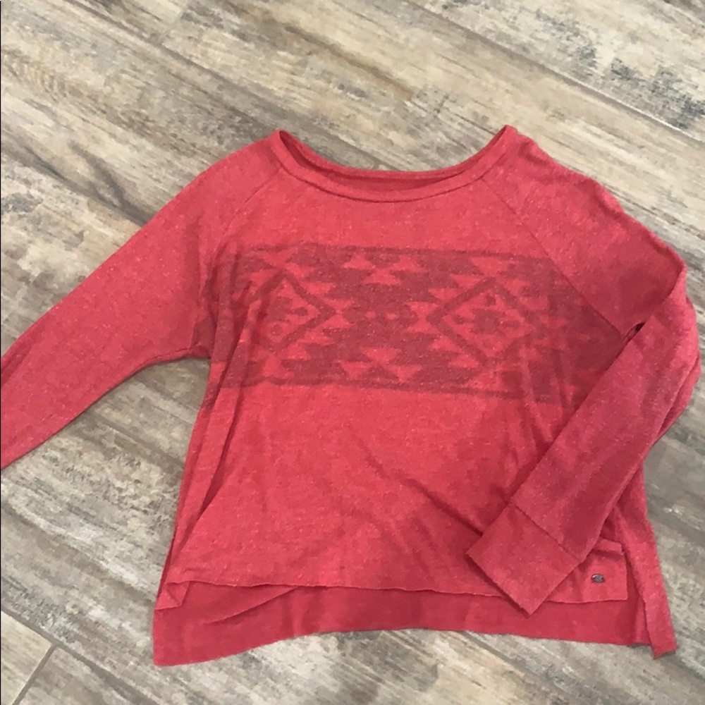 Pink sweater with pattern across chest